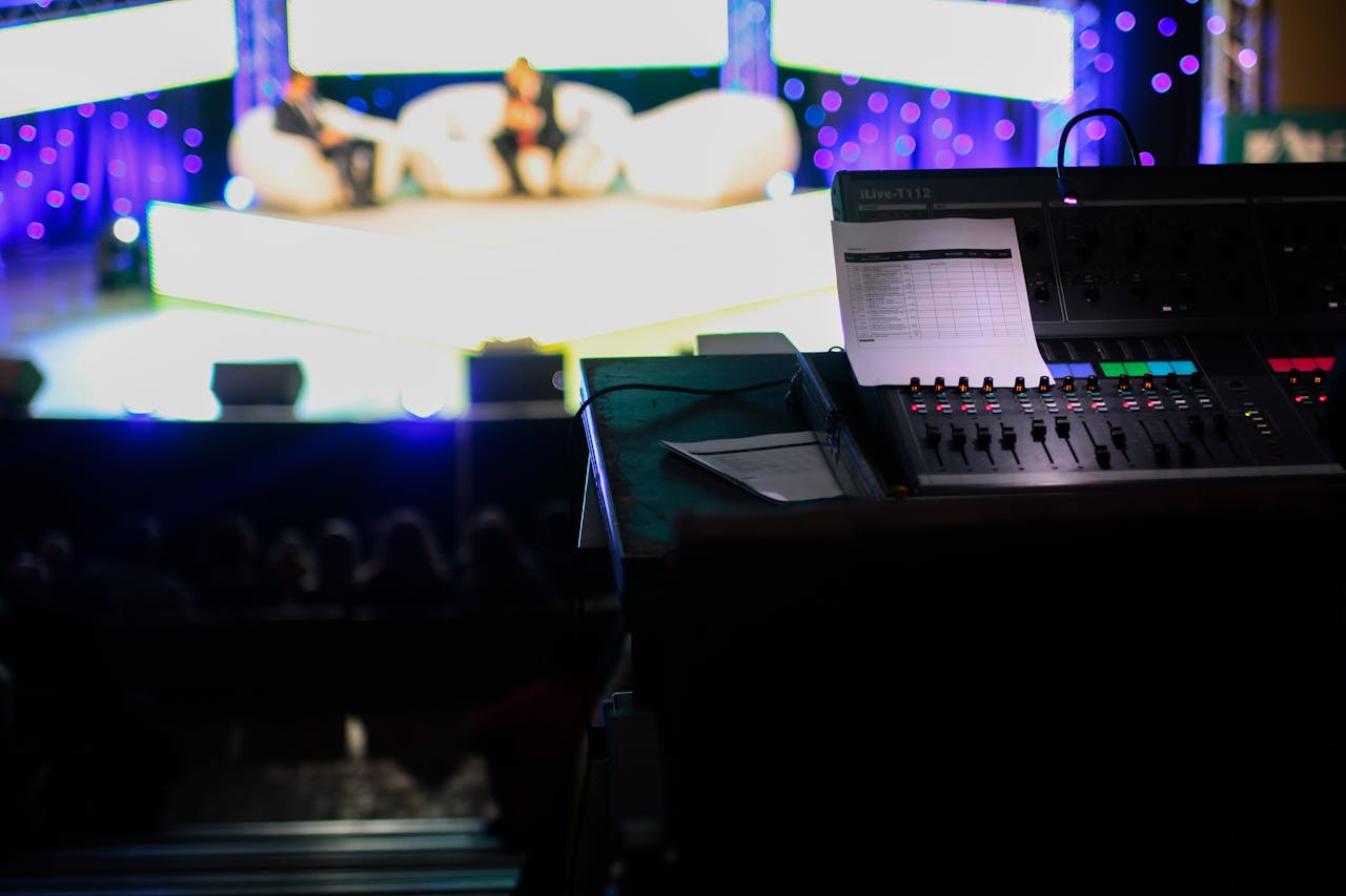 The Art of Drawing Readers In: Your attractive post title goes here Sound console in a studio setting for a live event with blurred audience view.