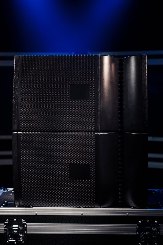 switched two sound speakers on the background of boxes with concert equipment